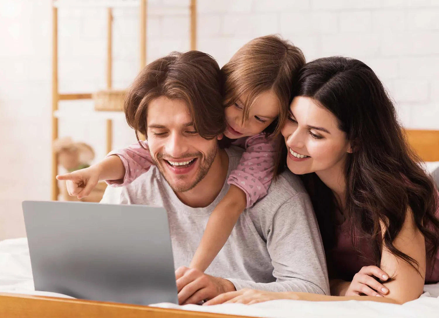 A family looking at a laptop together.